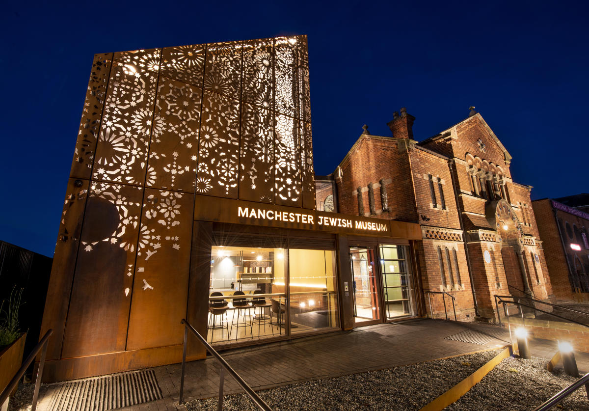 Illuminated exterior of Manchester Jewish Museum and its restored former synagogue at dusk
