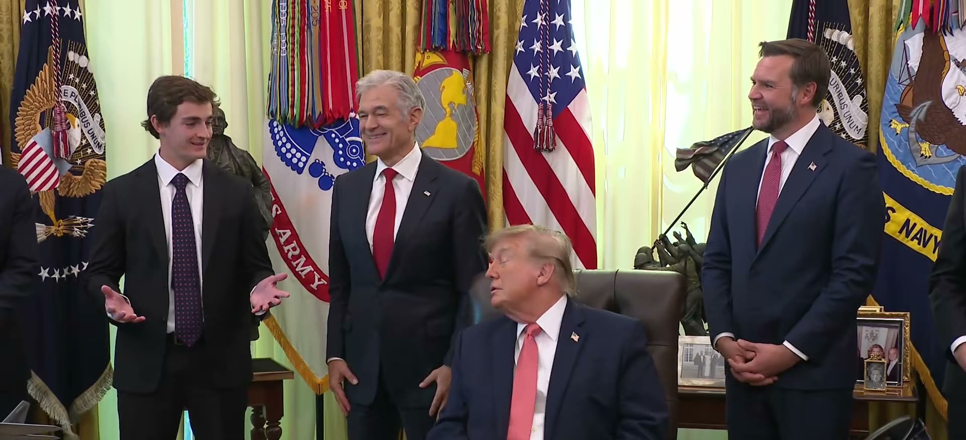 Nick Shirley speaking in the Oval Office as Dr Mehmet Oz and Vice President JD Vance look on and President Trump turns toward him