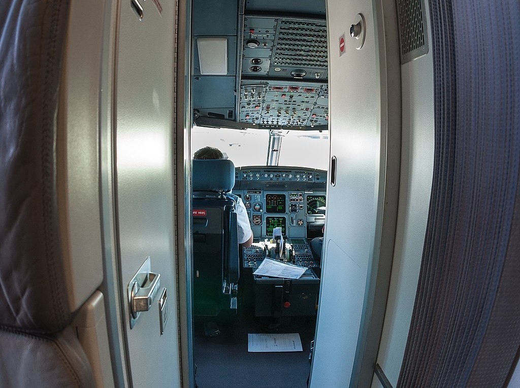 Reinforced cockpit door on a passenger aircraft, illustrating the aviation insider-threat challenge