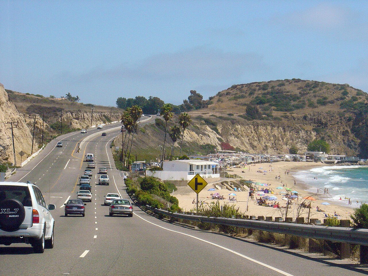 California king tides flooding — Pacific Coast Highway above the beach and bluffs near Crystal Cove and Laguna Beach