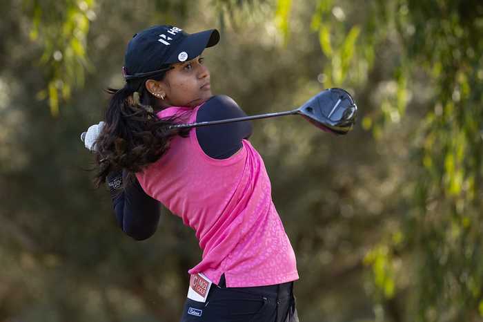 Indian golfer Pranavi Urs follows through on a tee shot