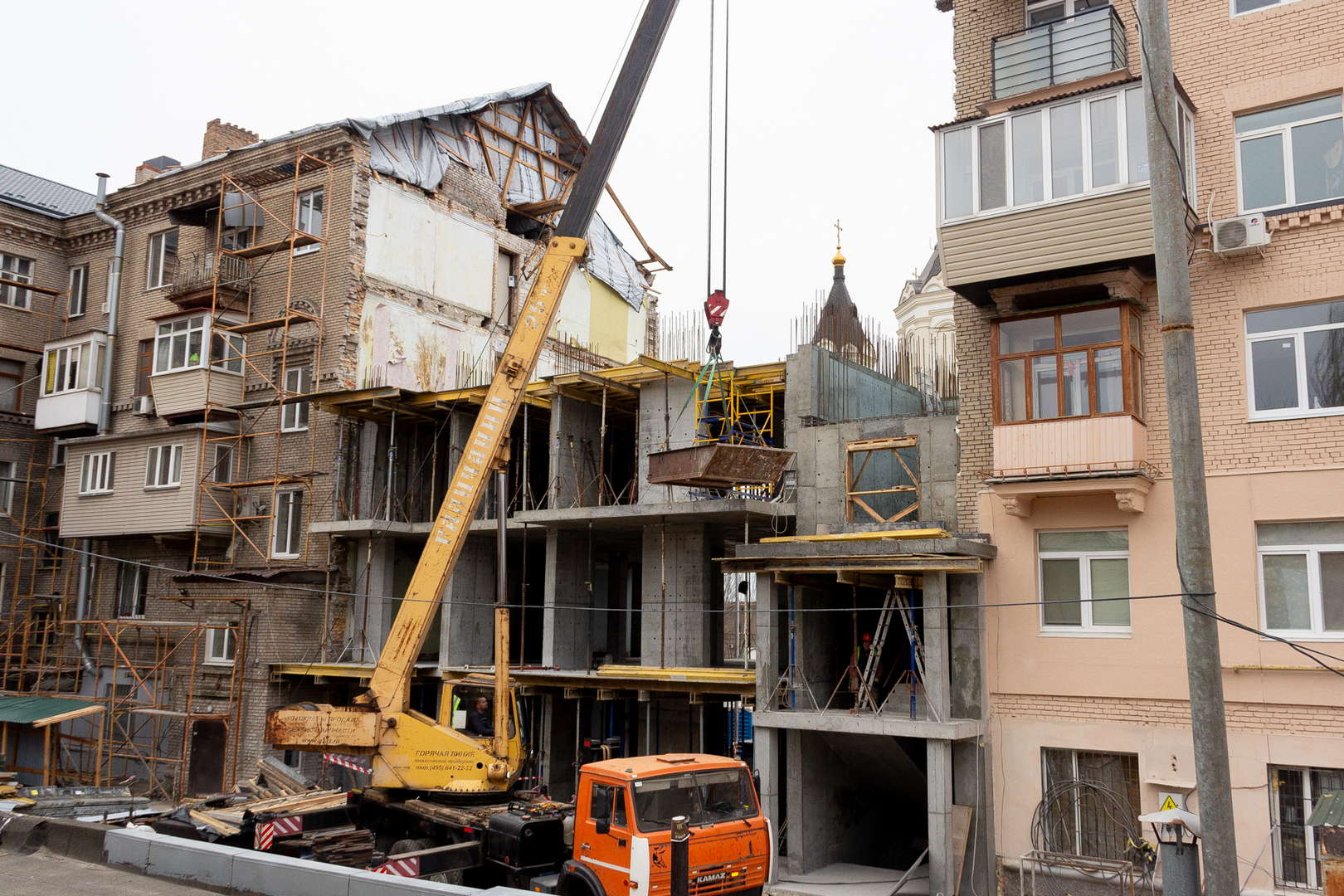 Workers rebuilding a Zaporizhzhia apartment building damaged by Russian shelling