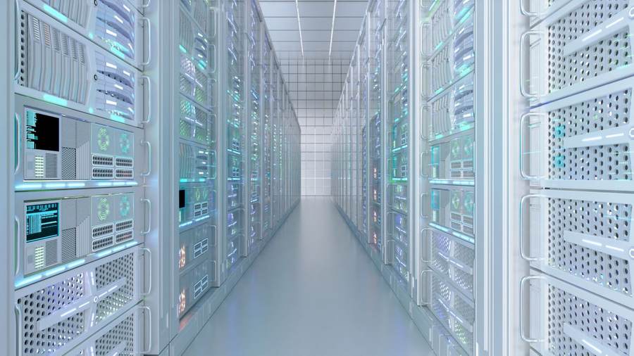 Rows of server racks inside a data center — the AI buildout driving electricity demand and household power bill concerns across the US