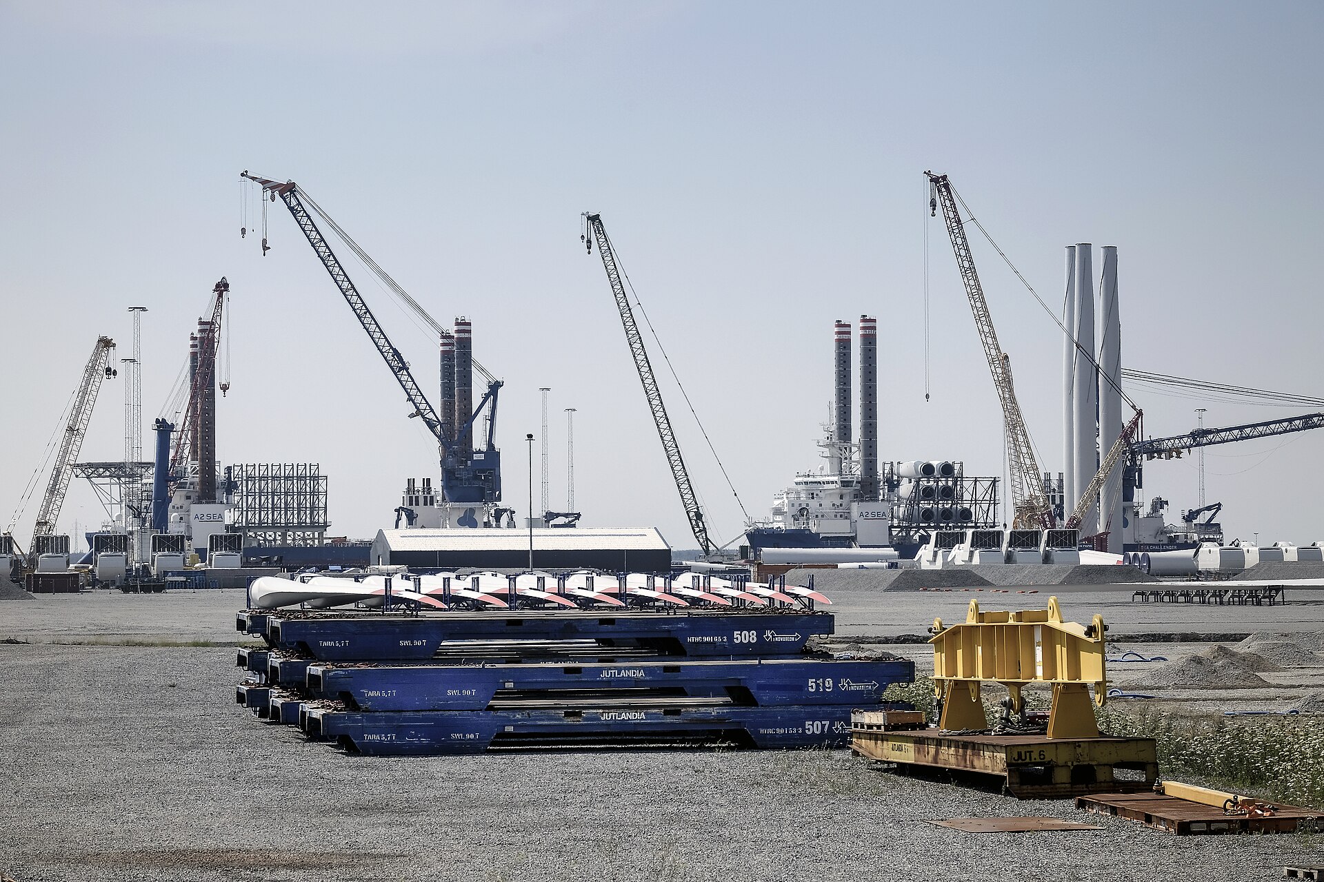 Offshore wind port at Esbjerg, Denmark, with turbine installation ships — Trump wind turbine tariffs talks target imported components