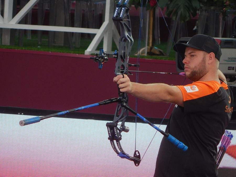 A men's compound archer competing at the Archery World Cup Final — India's men's team beat China 238-237 in the Asian Games 2026 final