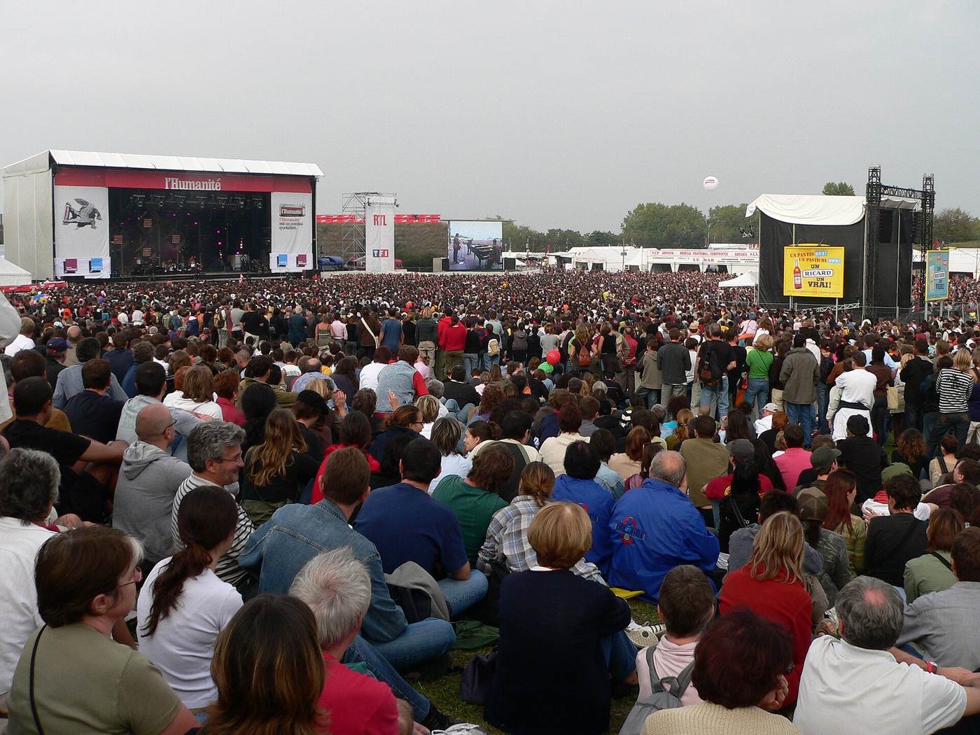 A dense outdoor music-festival crowd illustrating the scale of people, crews and vendors affected when large events are cancelled