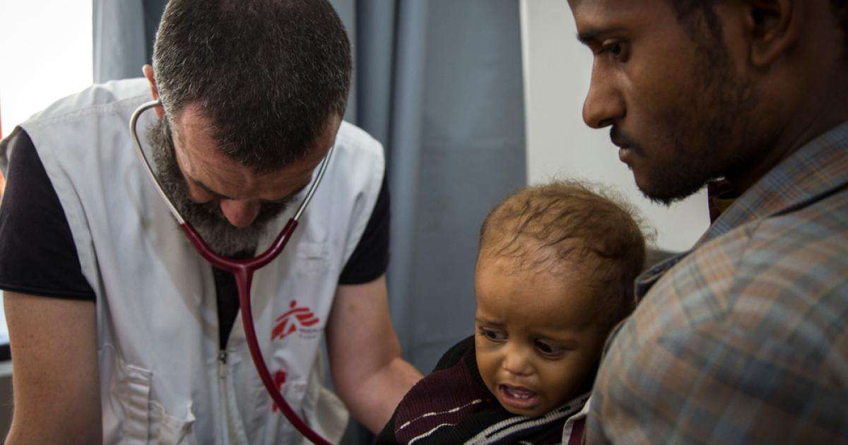 A Doctors Without Borders clinician examines a young child at Al Salam Hospital in Yemen