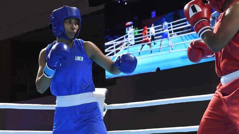 Lovlina Borgohain boxes in blue during a national competition, showing the controlled distance behind her Aichi-Nagoya gold