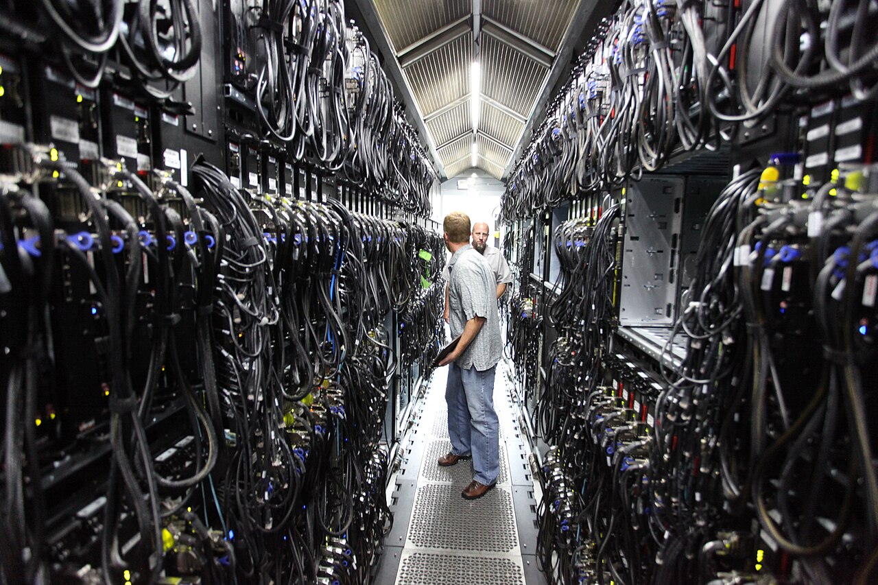 OpenAI no live internet training — technicians inside a data-centre server corridor, file photo