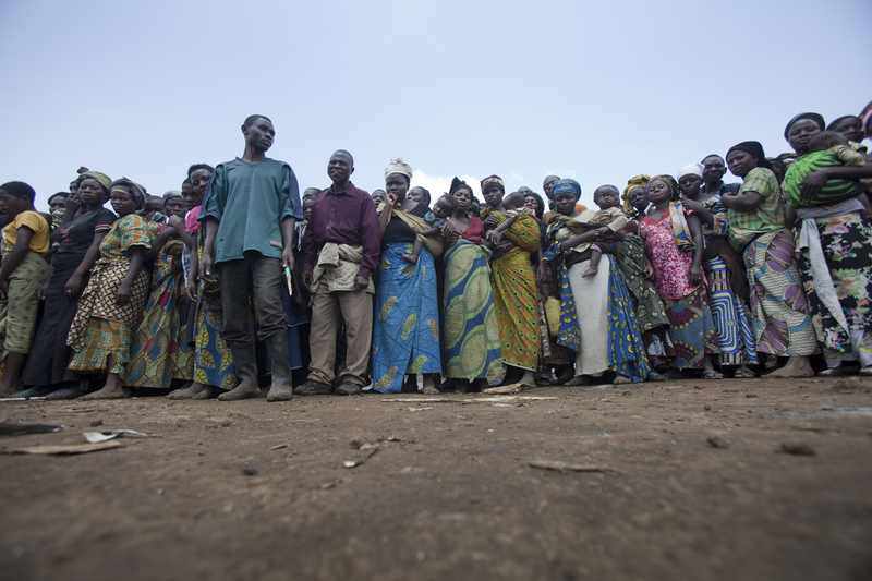Displaced people wait for a World Food Programme food distribution — the kind of frontline aid delivery CERF's underfunded-emergencies funding supports