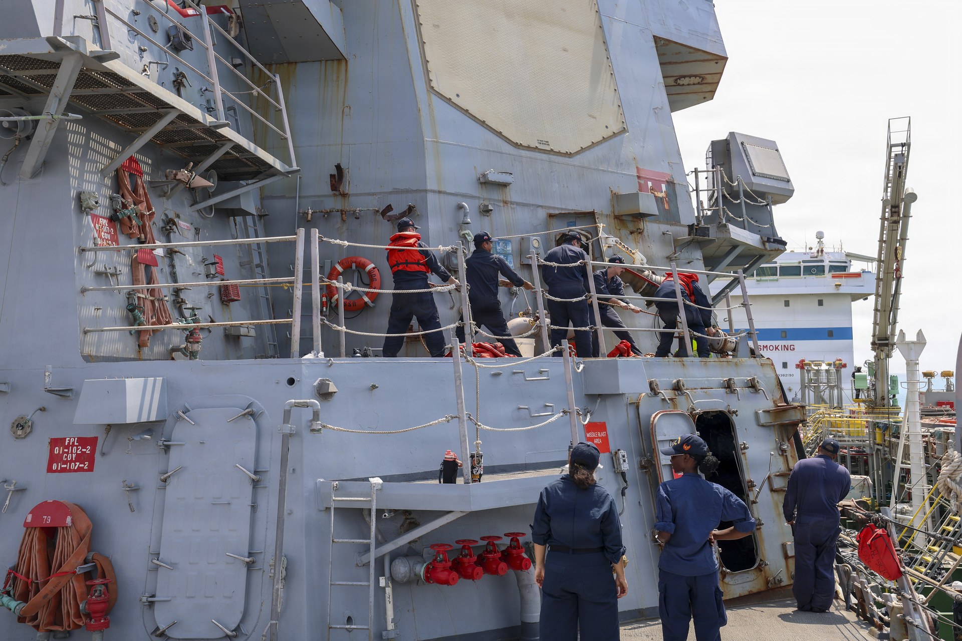The U.S. destroyer USS Oscar Austin taking on fuel alongside the pier during a port visit to Yanbu, Saudi Arabia, in September 2026