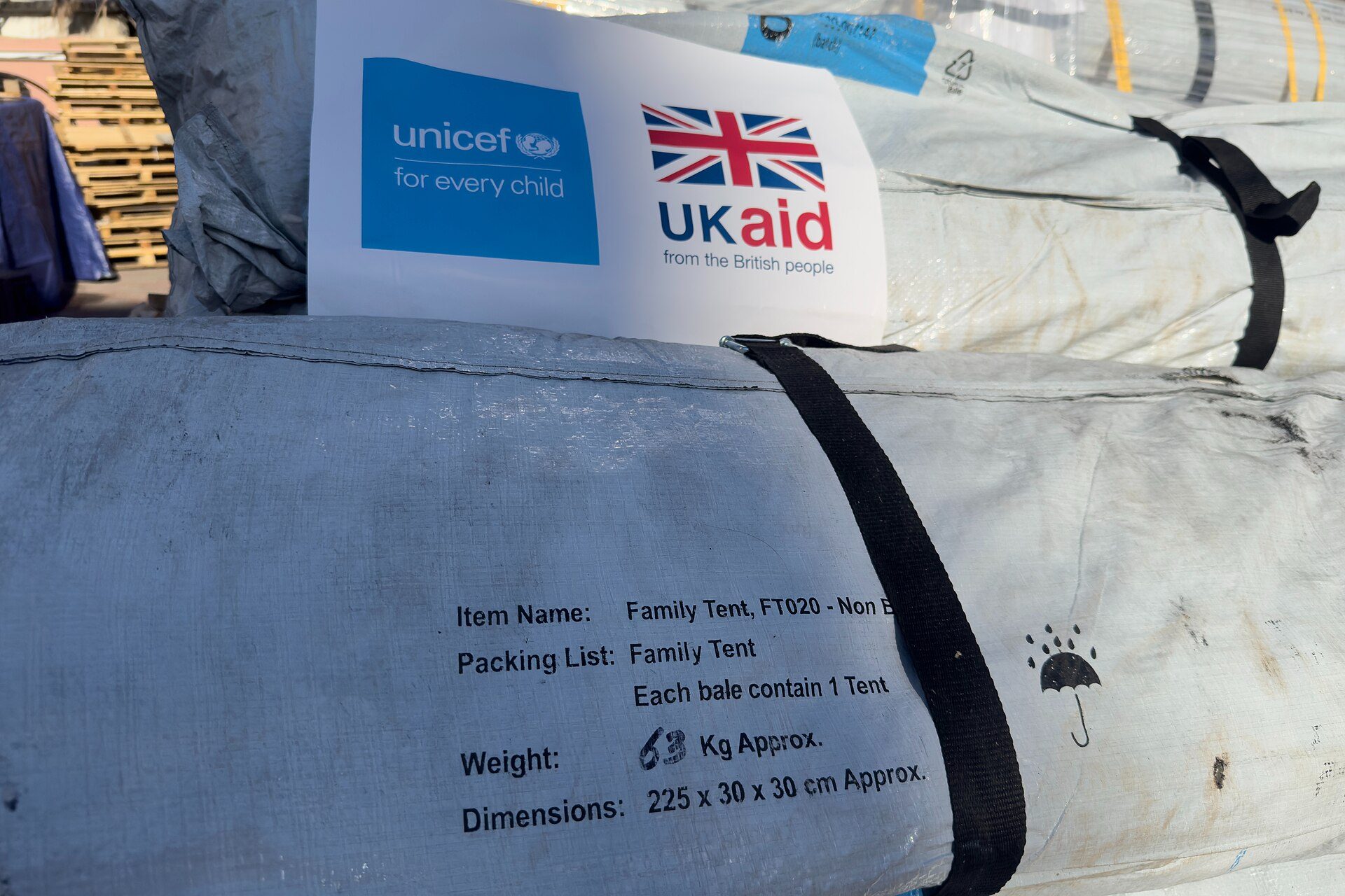 A baled family tent bearing UNICEF and UK aid labels, part of a UK-funded shipment of tents that arrived in Gaza on December 1, 2025 for distribution to displaced families — Gaza children ceasefire report file photograph