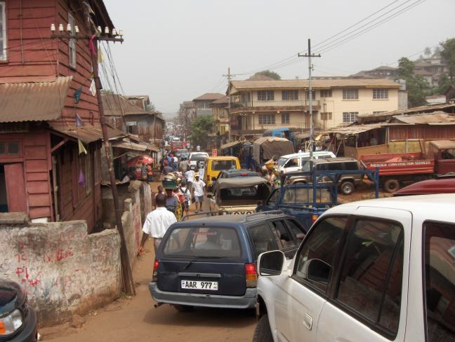 A busy street in Freetown, Sierra Leone, with traffic and pedestrians — US deportees Sierra Leone