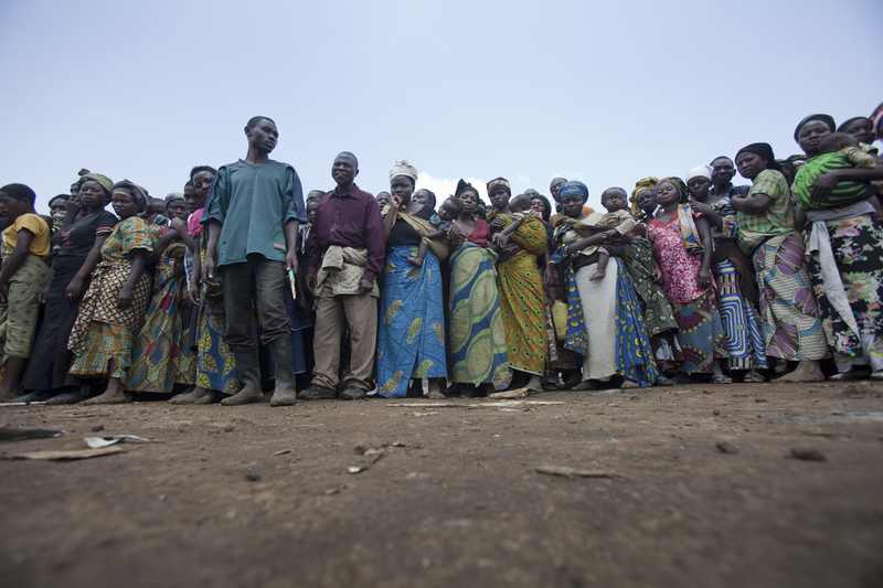 Displaced people wait for a World Food Programme food distribution — the kind of frontline aid delivery CERF's underfunded-emergencies funding supports