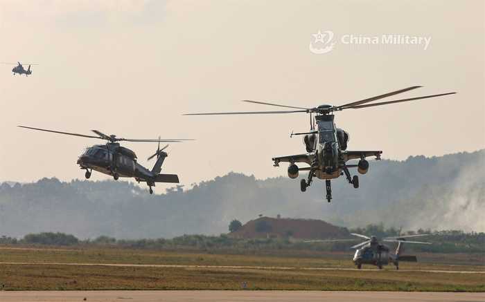Chinese and Lao helicopters operating during a joint exercise as the China Laos air base opens
