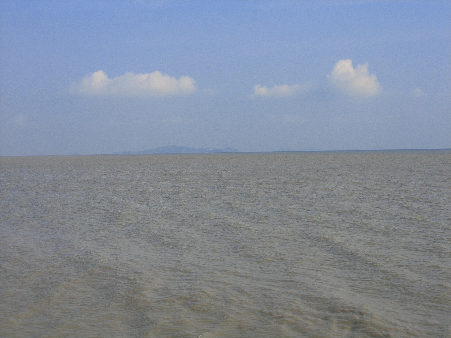The Strait of Malacca seen from Malacca city in Malaysia, with Sumatra, Indonesia, on the horizon — the tanker transited the strait before its seizure off Tanjung Balai