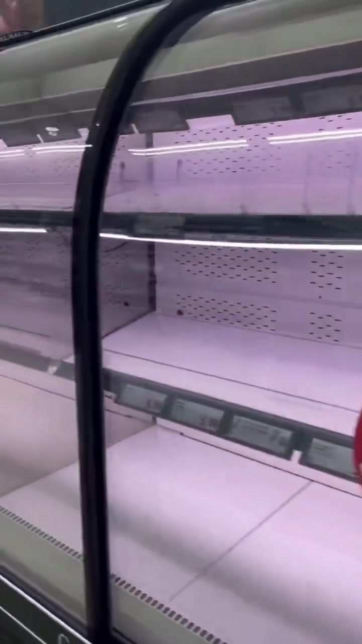 Italy truckers protest — an emptied refrigerated meat case in an Italian discount supermarket