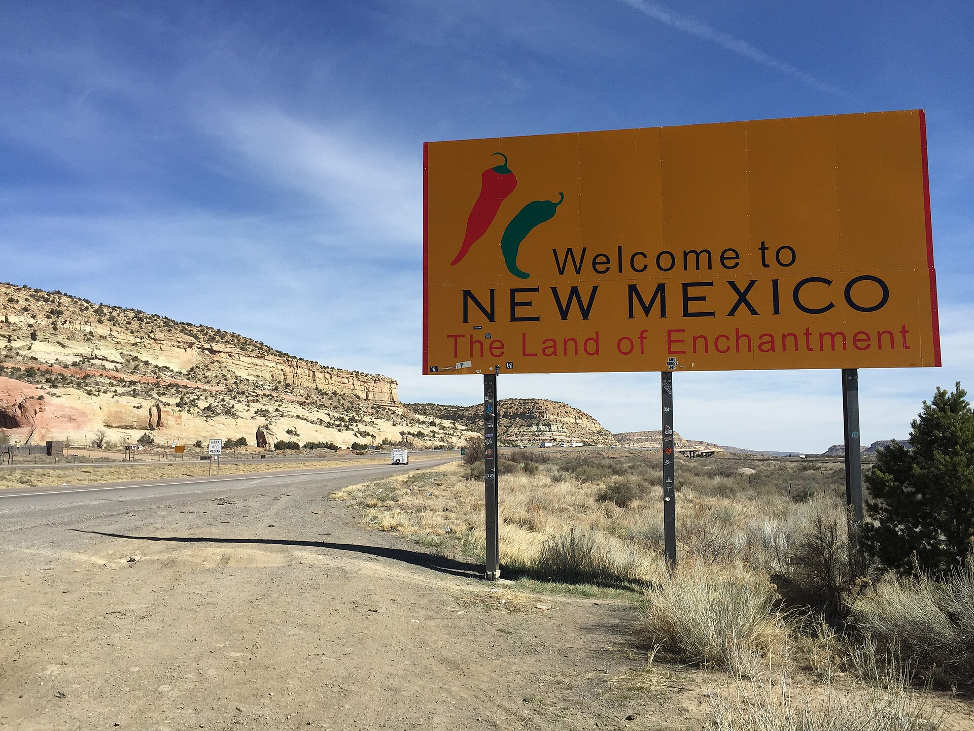 The 'Welcome to New Mexico — The Land of Enchantment' sign on Interstate 40 at the Arizona state line