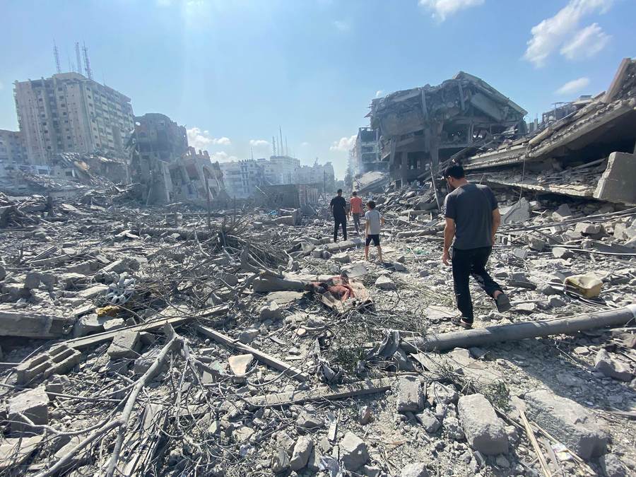 Palestinians inspect rubble in Gaza City after an airstrike — the kind of destruction the October 2025 ceasefire was meant to stop