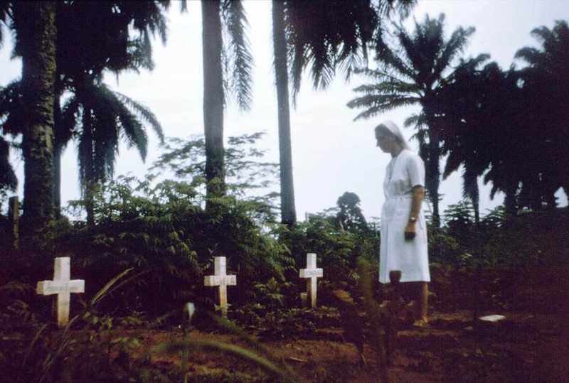 A nurse walks among the graves of victims of the 1976 Ebola outbreak in Zaire — the virus's first known appearance, in what is now DR Congo