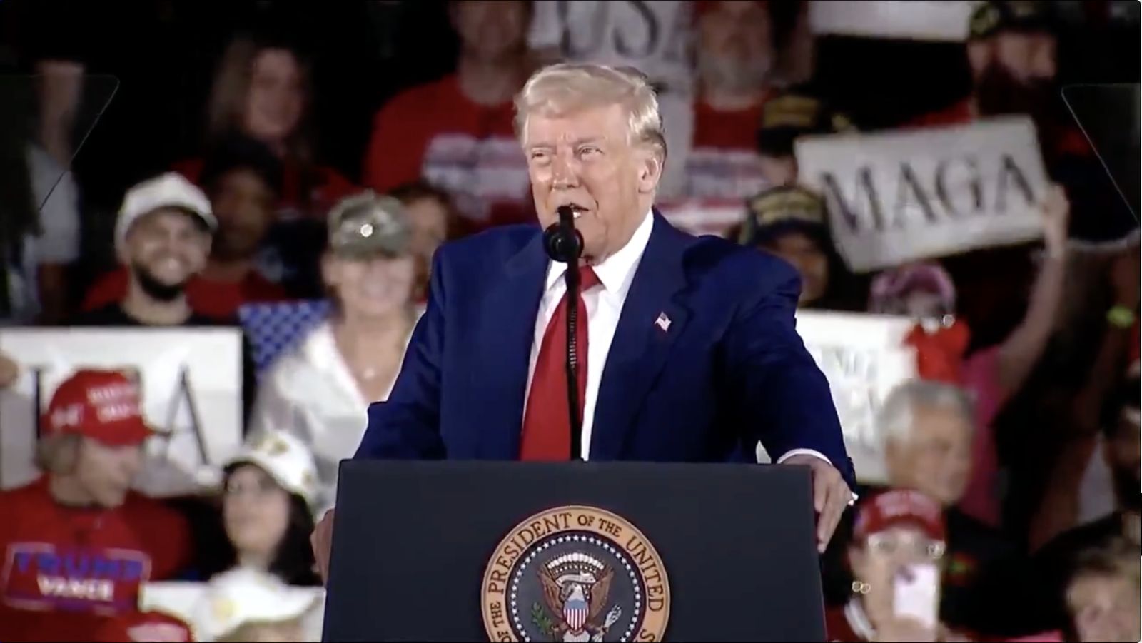 Trump take care of Cuba — President Donald Trump speaking at a rally podium before supporters