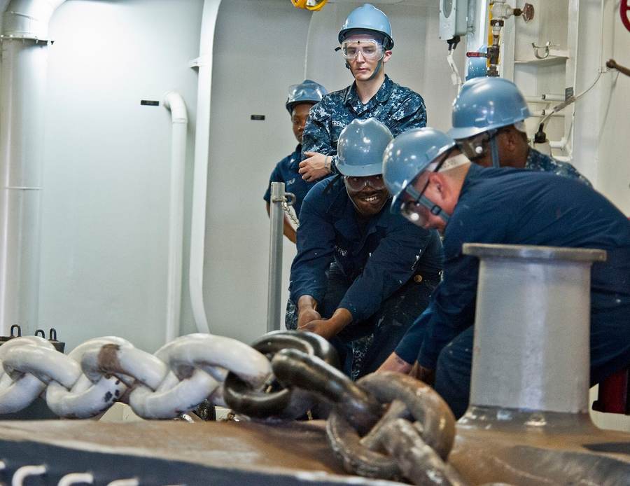 Sailors raise the anchor aboard USS Makin Island during its maiden deployment
