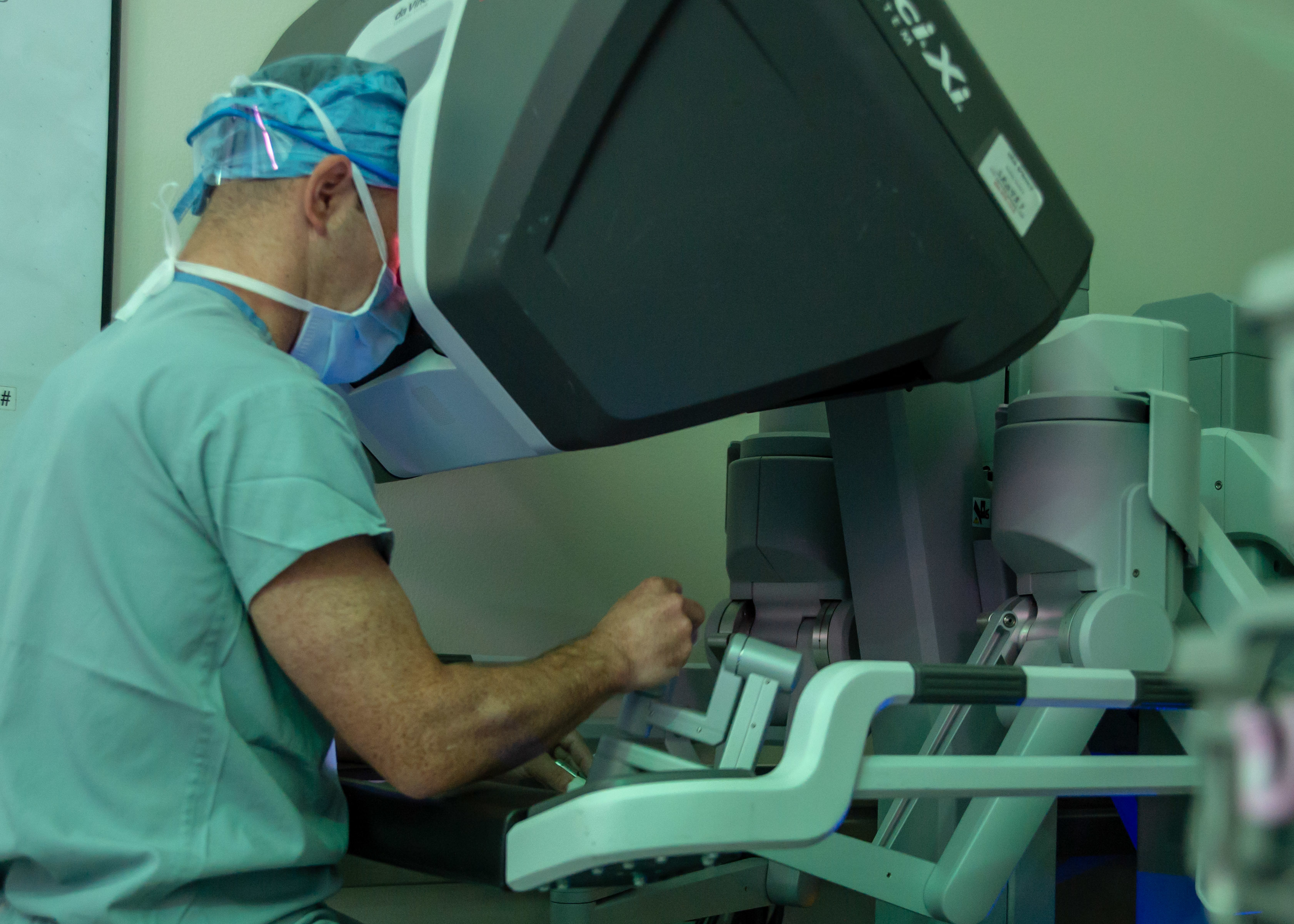 A surgeon at the console of a da Vinci Xi system during robot-assisted surgery