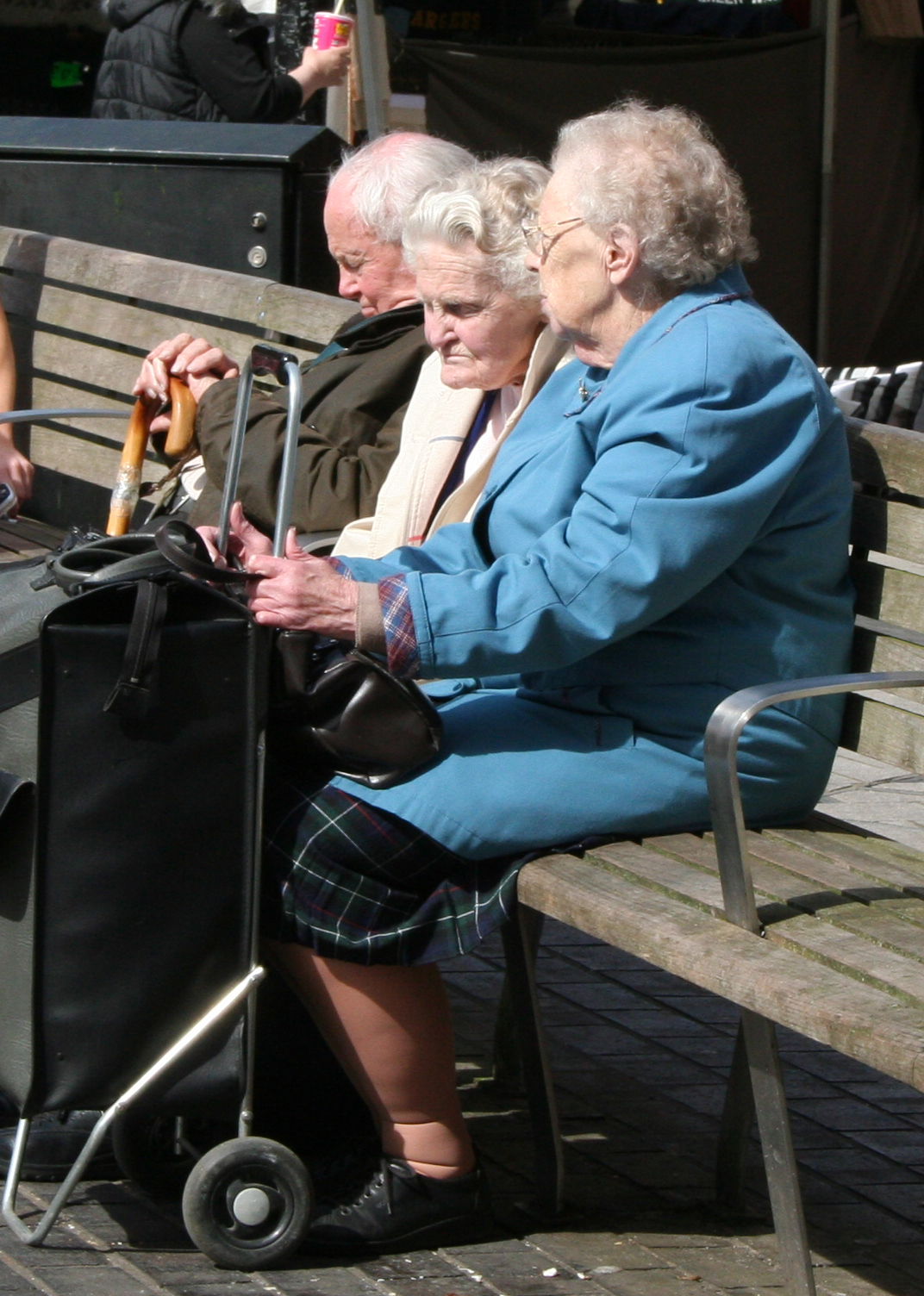Three pensioners sitting on a bench in Redhill, Surrey, in a file photo — pensioners whose only income is the state pension are the group the Budget measure is designed to protect