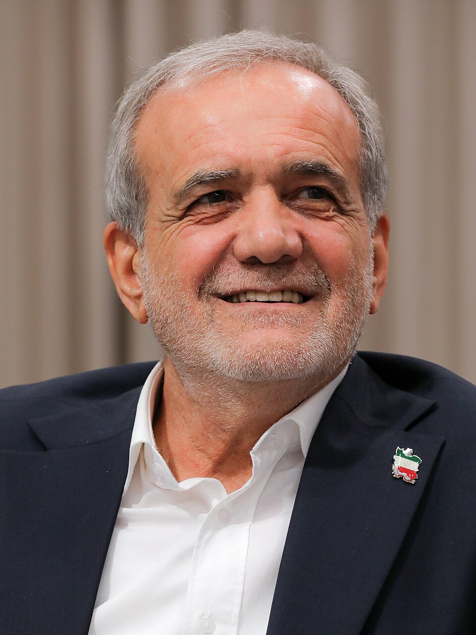 Iranian President Masoud Pezeshkian speaking at a podium in a 2025 file photograph