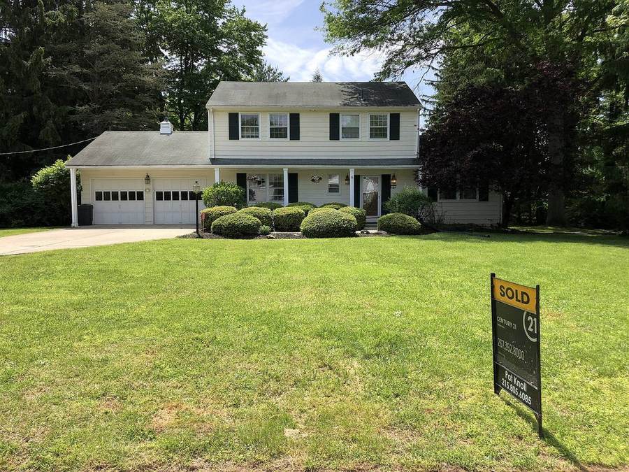 A 'Sold' sign in front of a suburban house after the seller accepted the buyer's offer