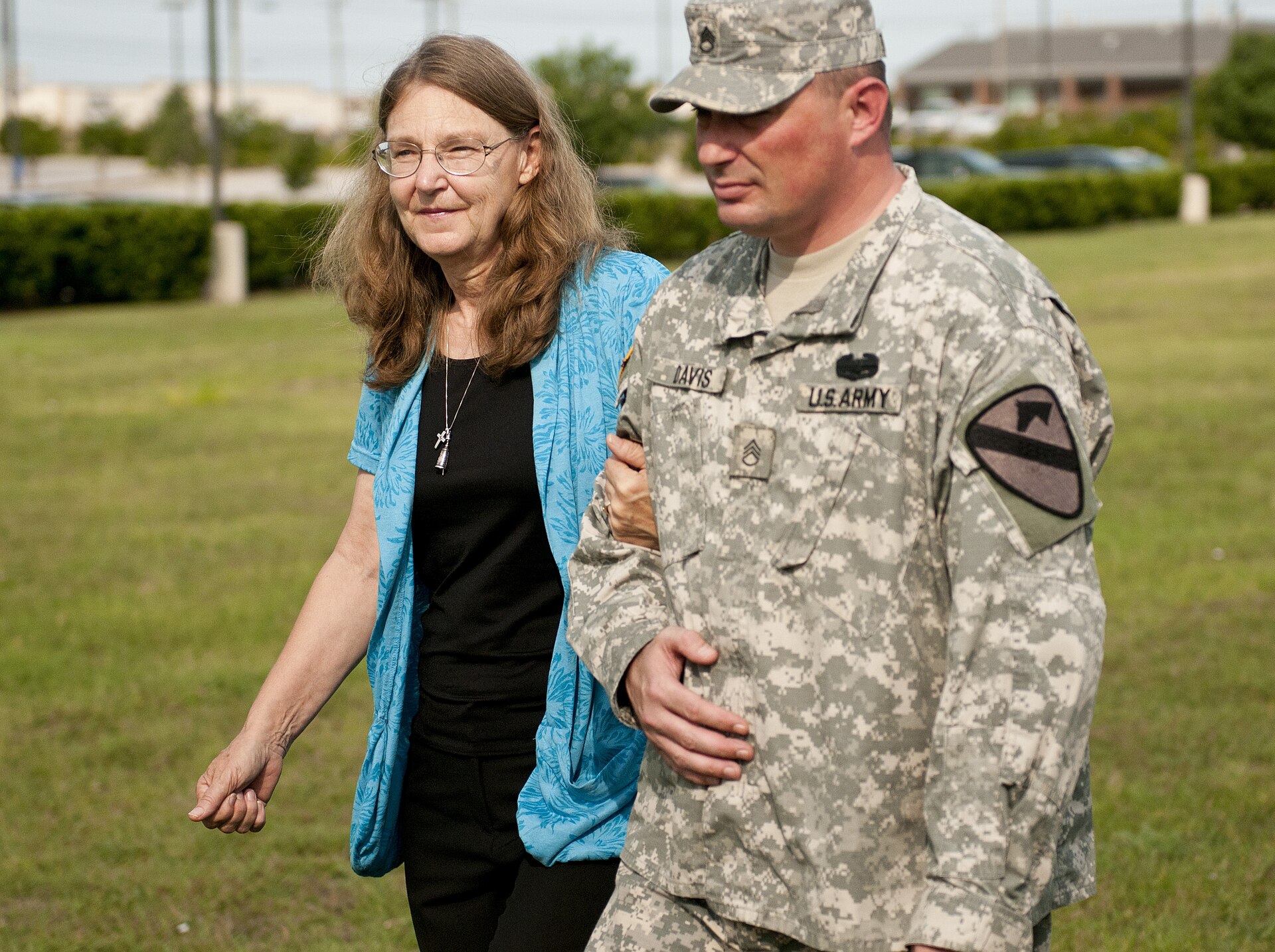 A wounded Fort Hood survivor escorts the widow of a man killed in the 2009 attack at the Fort Hood memorial groundbreaking