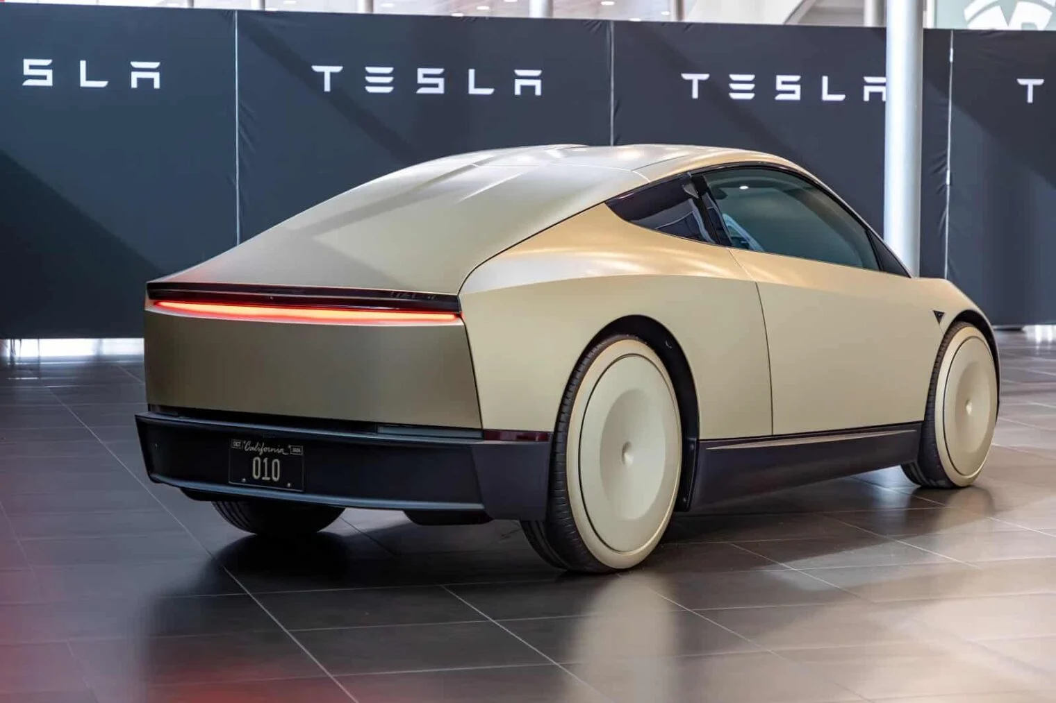 Tesla Cybercab displayed in Madrid, one of the autonomous vehicle programs targeted by Tesla AI spending