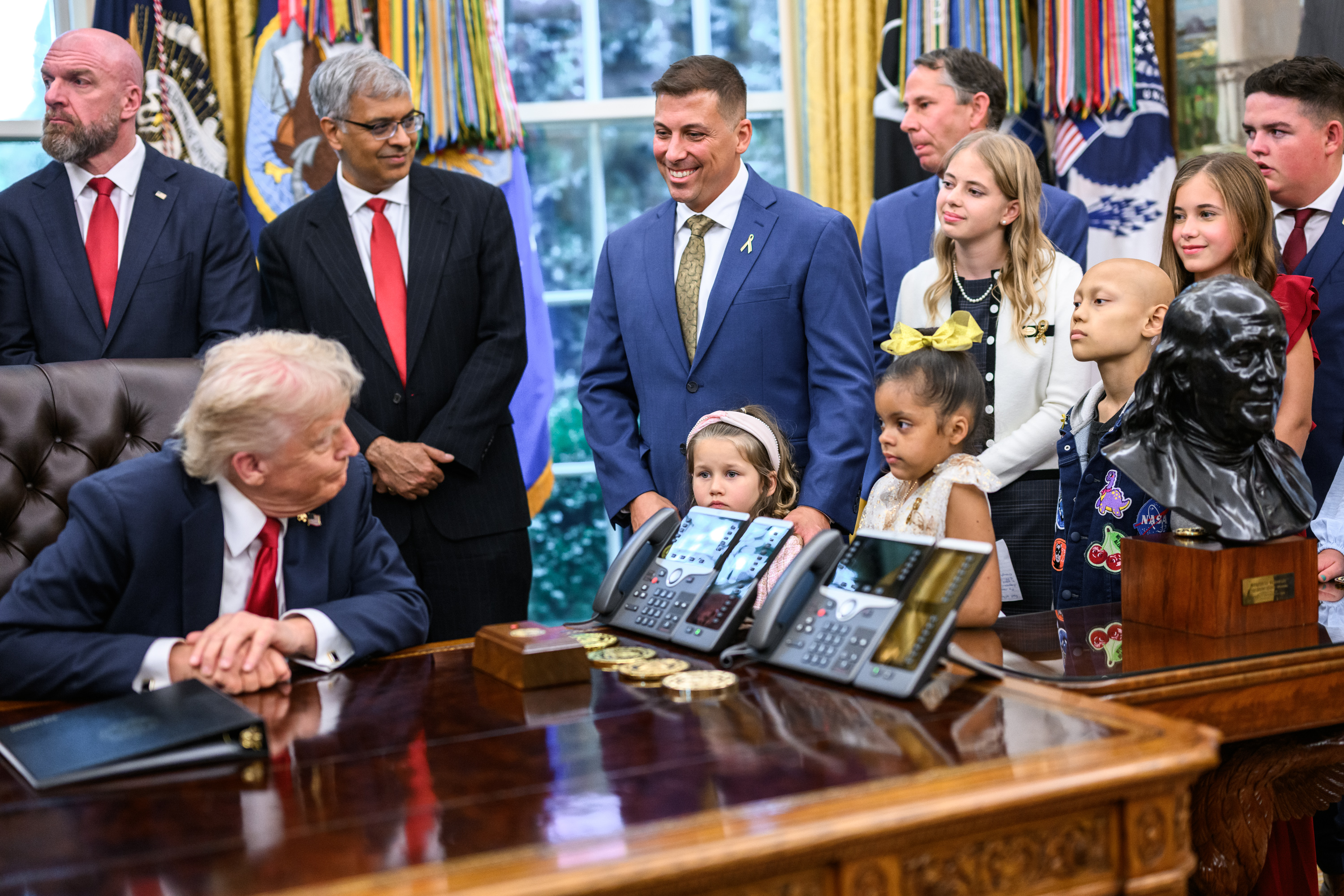 Trump approval rating today October 2026 — President Donald Trump signing an executive order at the Resolute desk in the Oval Office, file photo