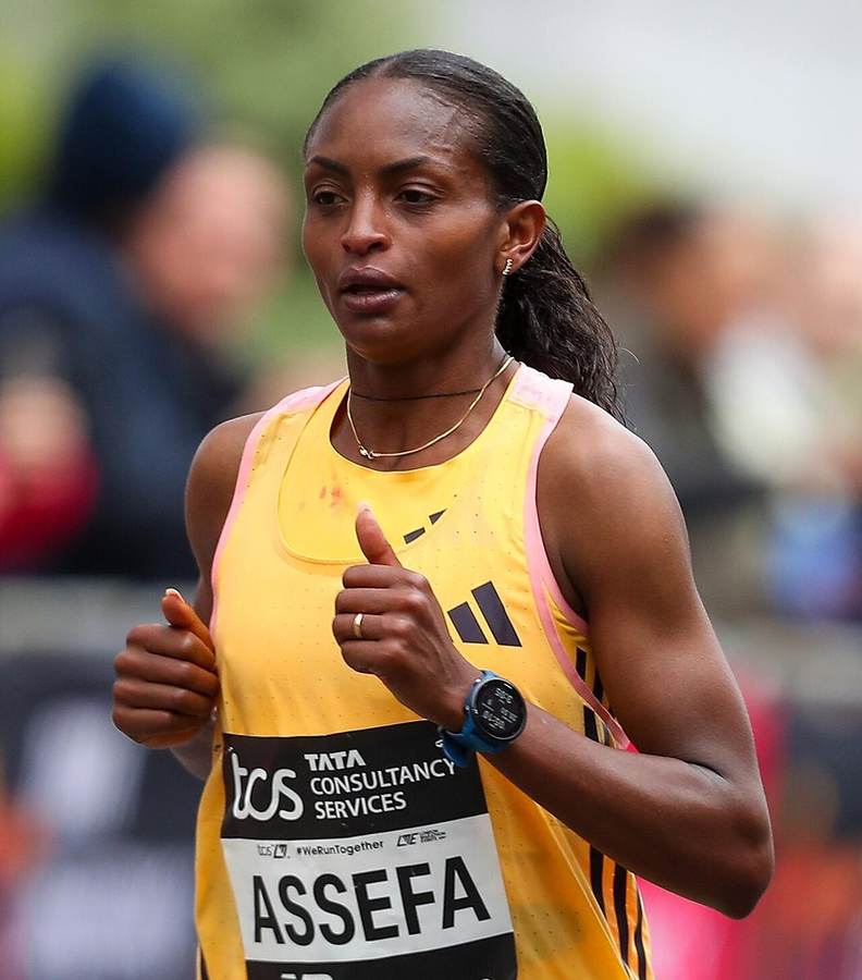 Tigst Assefa of Ethiopia, wearing her ASSEFA race bib, in action — she won the 2026 Berlin Marathon in 2:11:04, the third-fastest women's marathon in history