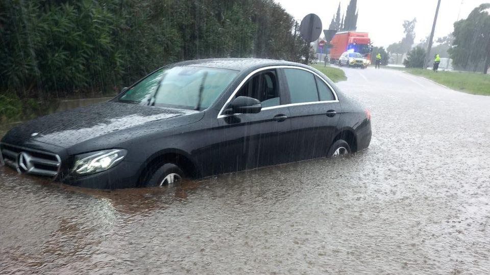 Flooded car on a rain-swamped road illustrating Catalonia floods October 2026 coverage