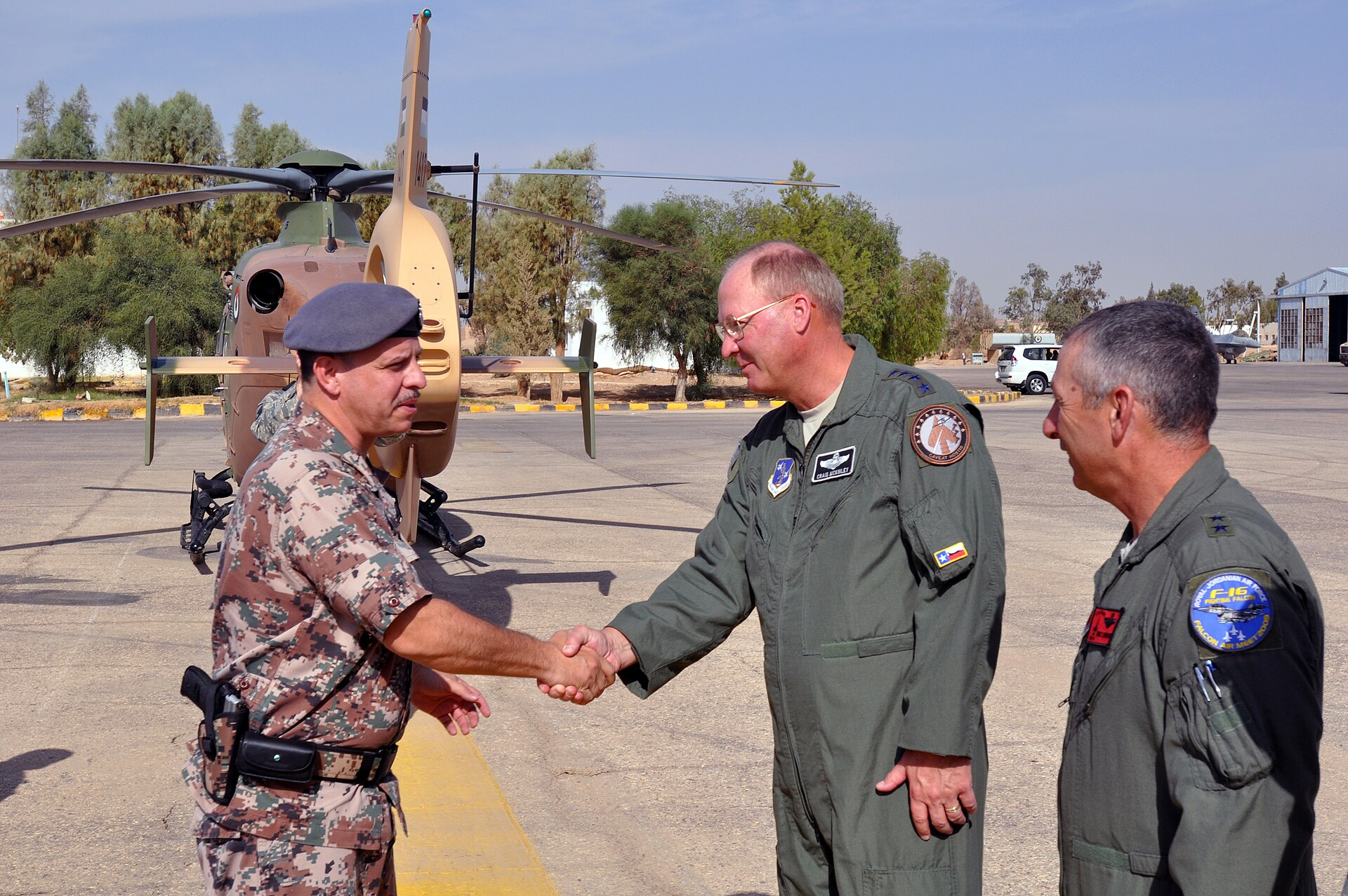 A Jordanian officer shakes hands with a U.S. air force general in front of a helicopter at Muwaffaq Salti Air Base, Azraq, during the Falcon Air Meet — file photo