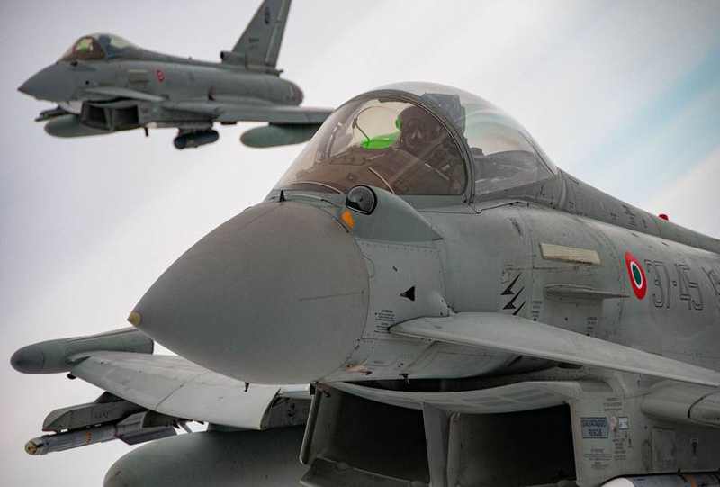 Two Italian Eurofighter Typhoon jets flying during a NATO Baltic Air Policing deployment