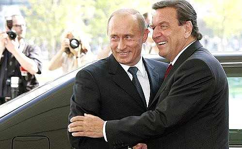 Vladimir Putin greeting Gerhard Schroeder as the Schroeder Putin birthday outrage revives scrutiny of their relationship