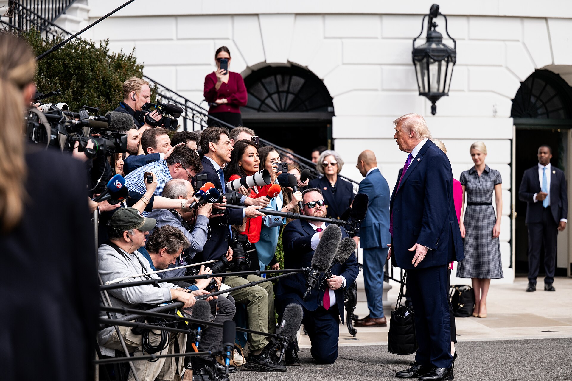 Trump Iran war end — President Donald Trump speaks with members of the media on the South Lawn of the White House, the setting for his Friday remarks on finishing the Iran war or letting it wither