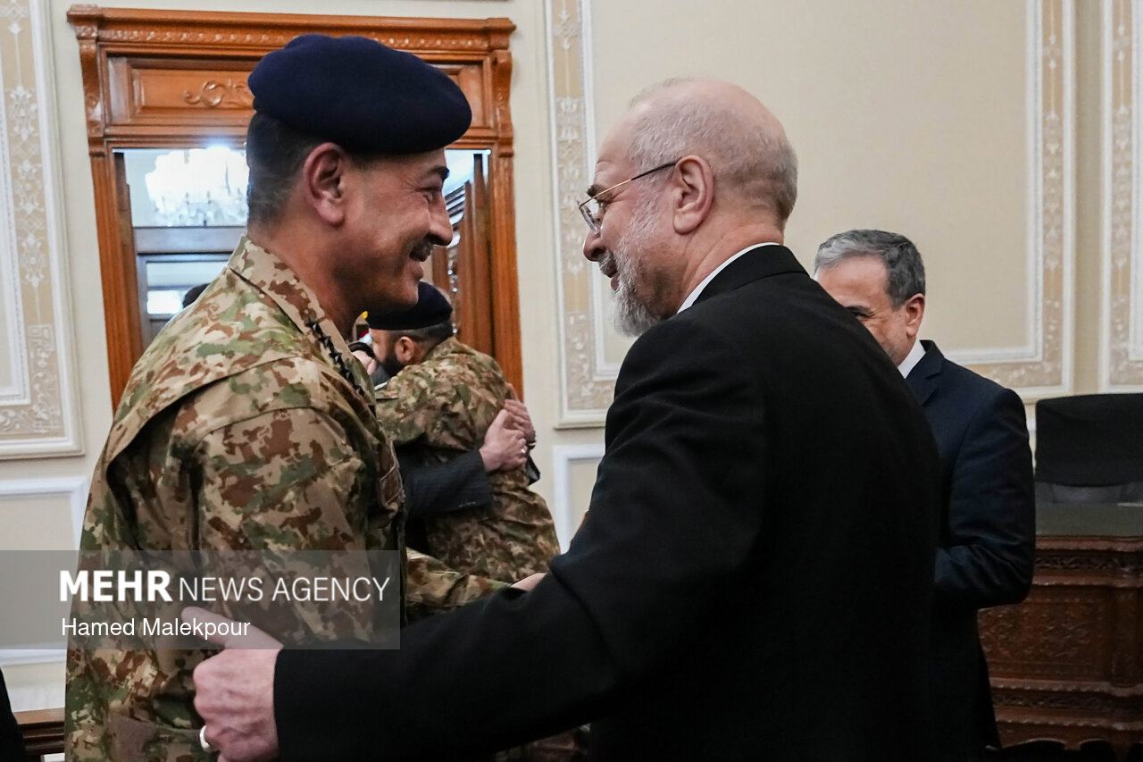 Pakistan army chief Field Marshal Asim Munir greets Iranian parliament speaker Mohammad Bagher Ghalibaf during a meeting in Tehran