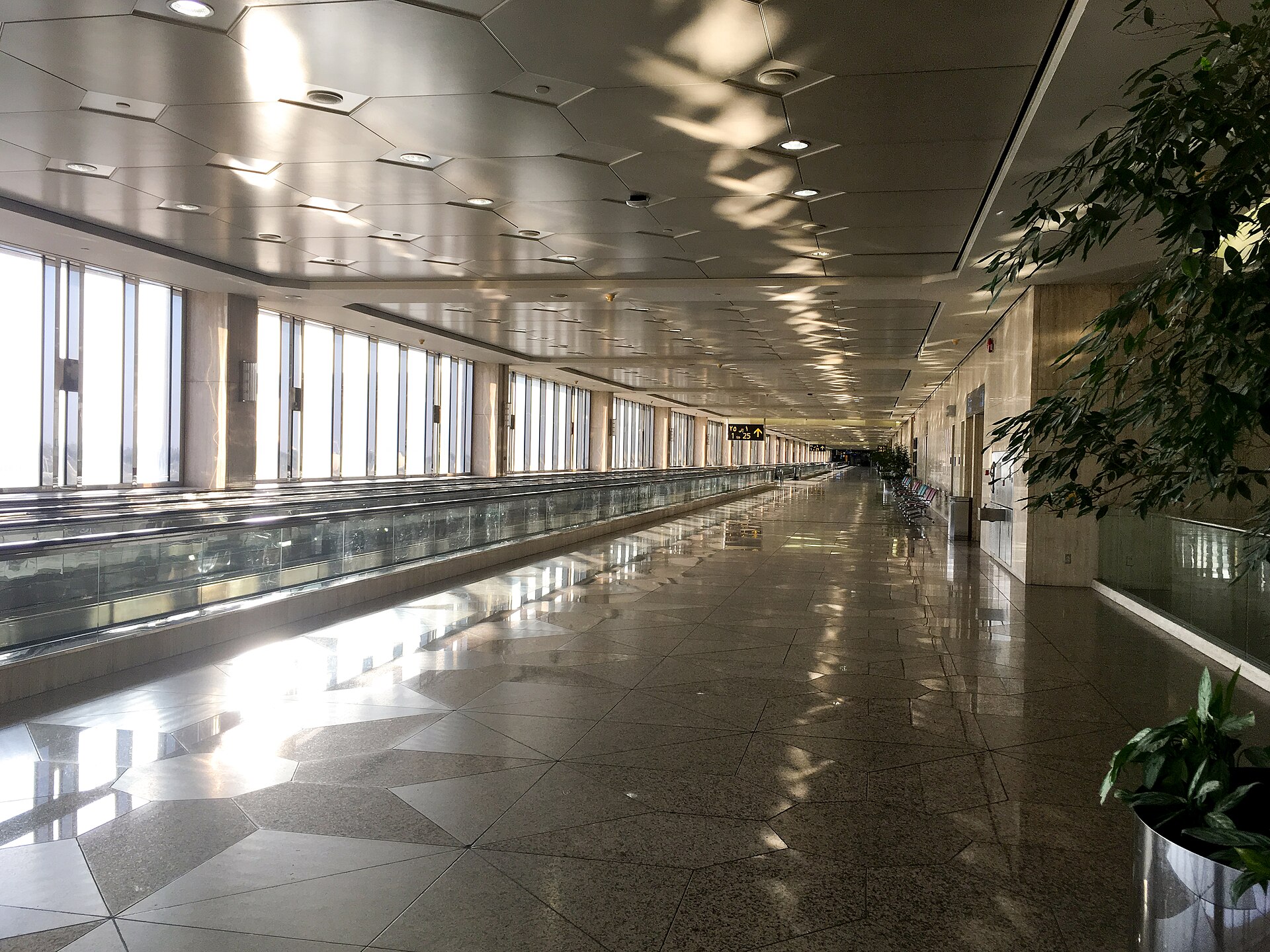 Terminal hall at King Fahd International Airport Dammam with moving walkways and gate signage