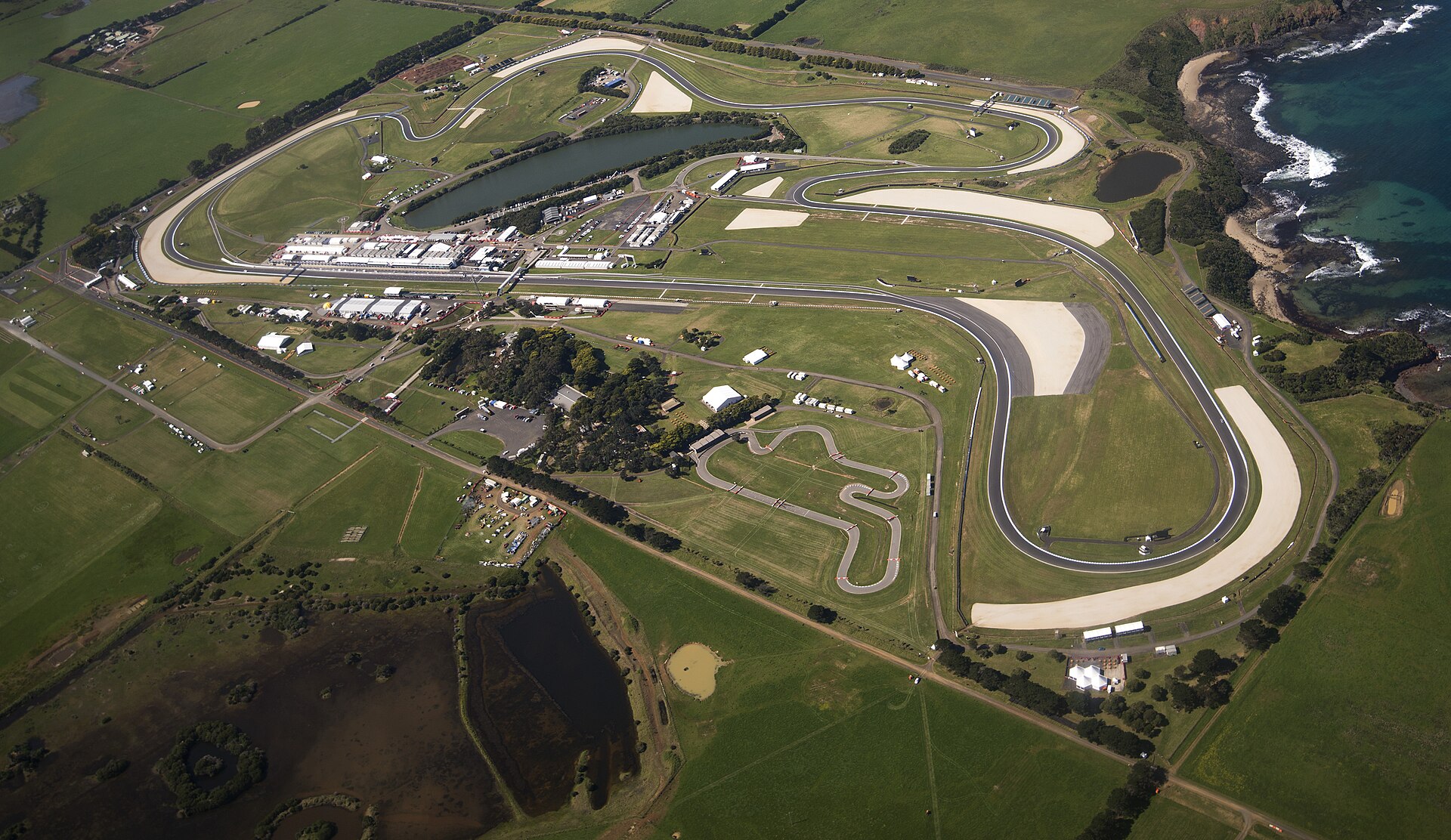 Australian MotoGP cancelled story — aerial view of the Phillip Island Grand Prix Circuit beside the sea in Victoria, Australia