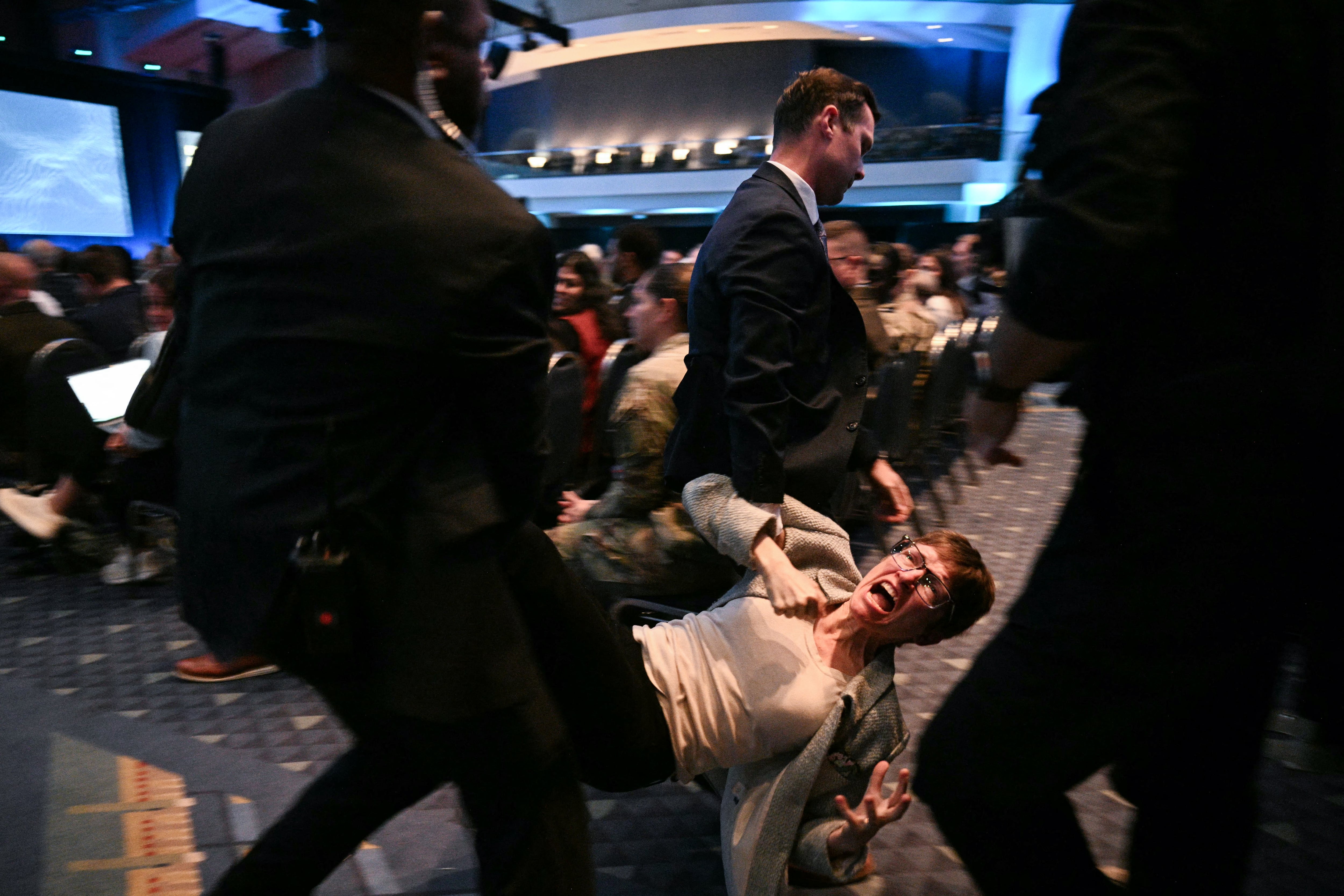 A protester is removed by security personnel as Defense Secretary Pete Hegseth speaks at the AUSA 2026 Annual Meeting and Exposition in Washington — Hegseth protesters AUSA panel