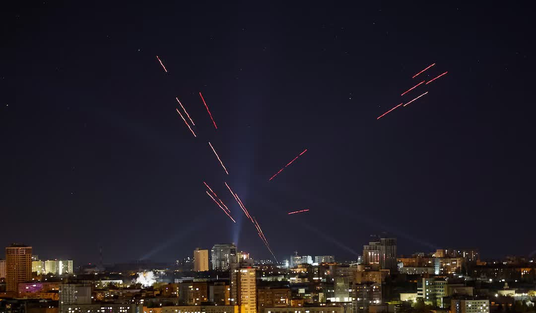 Air-defence tracers and interceptor fire streak across the night sky over a city during a drone attack — file photo for the Ukraine war day 1699 briefing