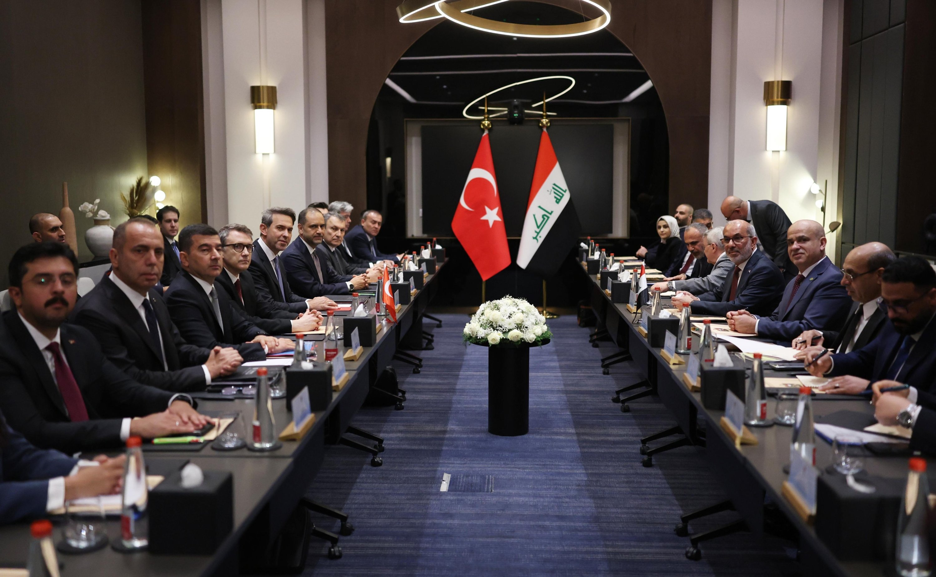 Iraqi and Turkish delegations meeting for bilateral energy talks with both countries' flags displayed