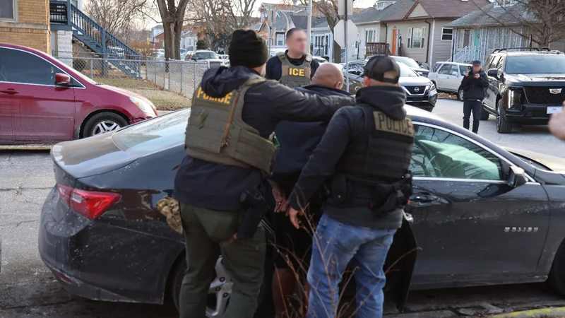 ICE agents during an enforcement operation as the agency prepares policy for electric shock gloves