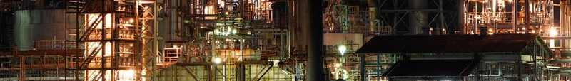 An oil refinery illuminated at night, representing Lukoil's international energy assets