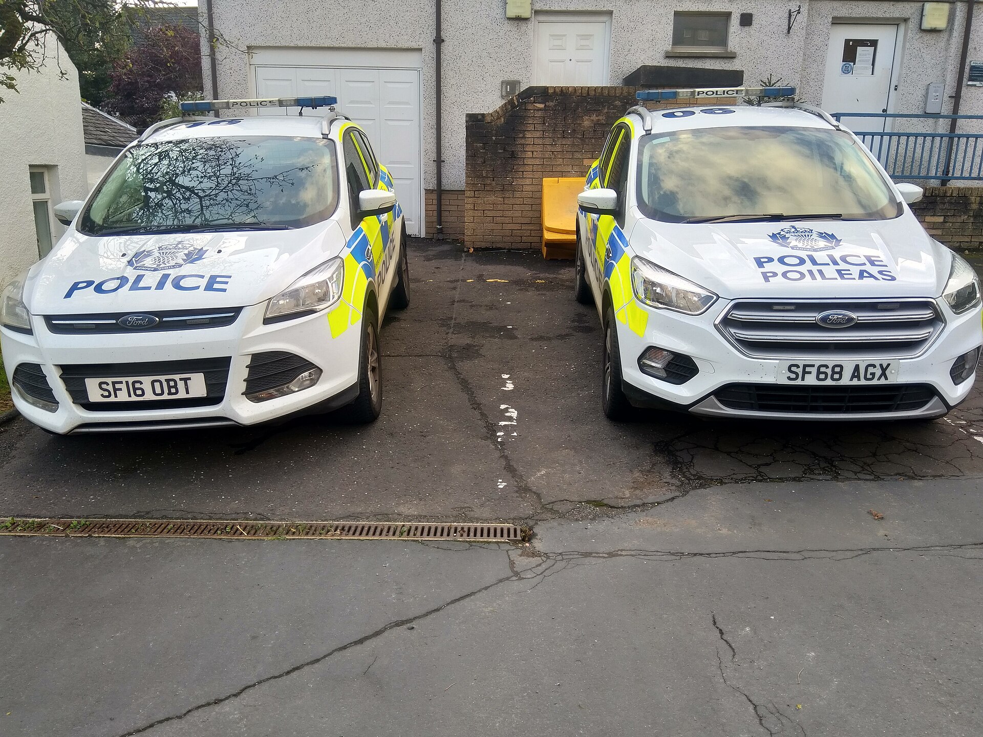 Two Police Scotland patrol cars, one with bilingual Police Poileas markings