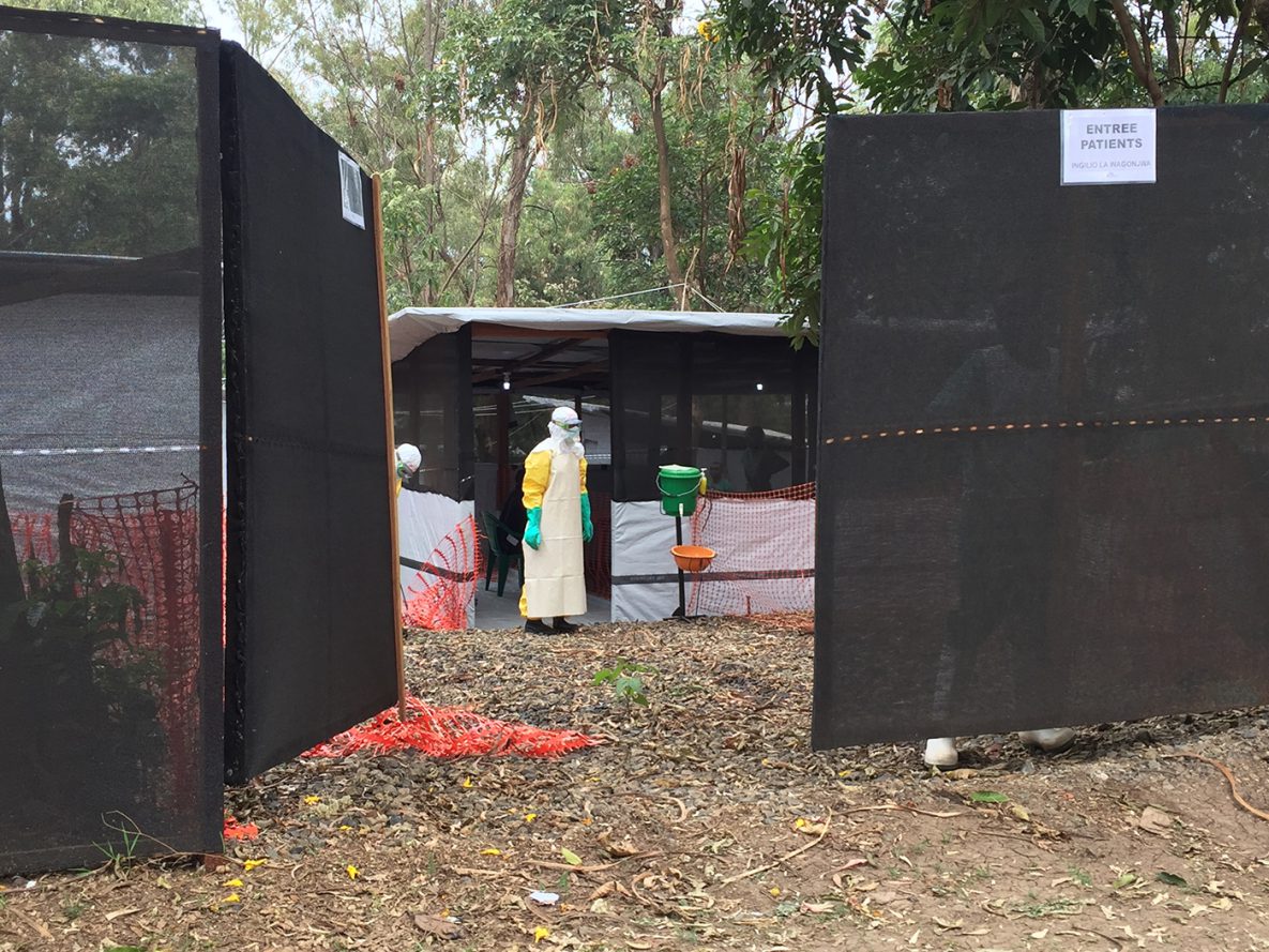 Ebola health worker in full protective equipment waits at the patient entrance of an Ebola transit centre in Congo