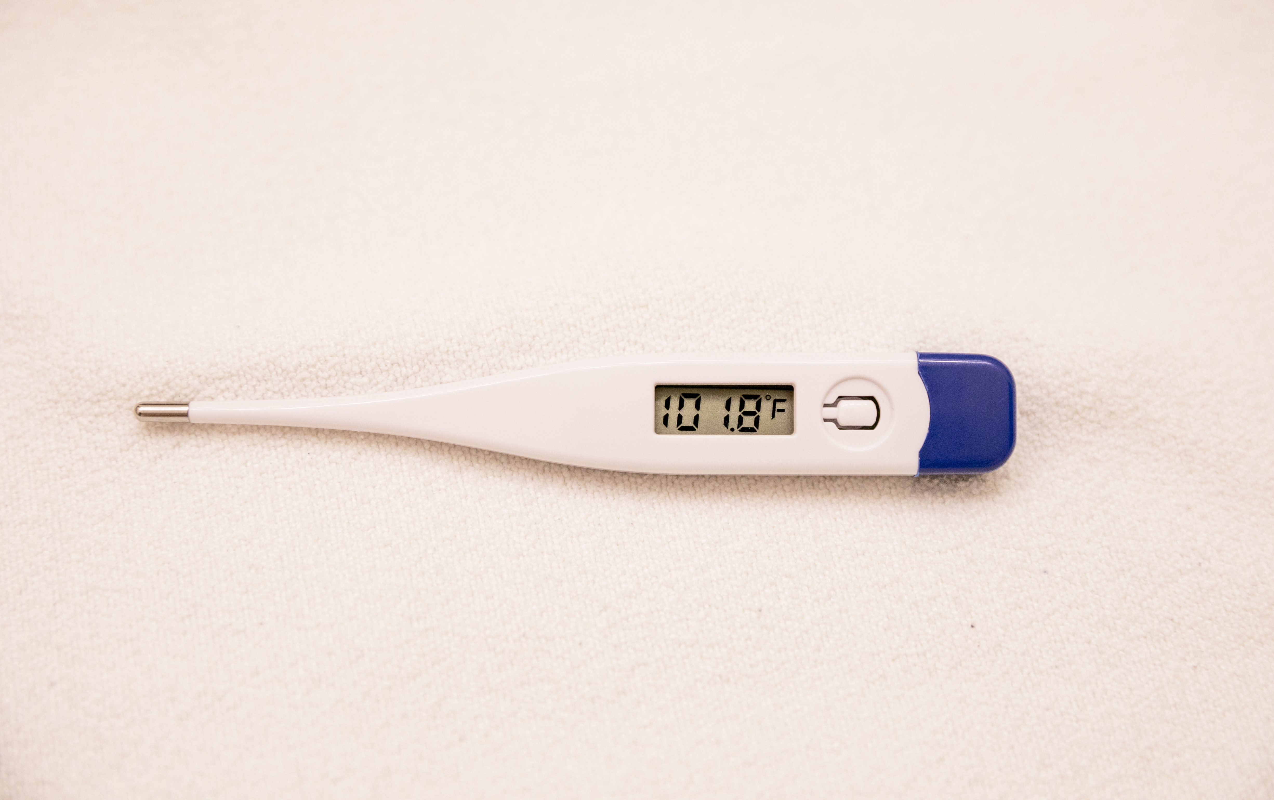 Thermometer showing fever — sudden high fever marks the end of the plague incubation period